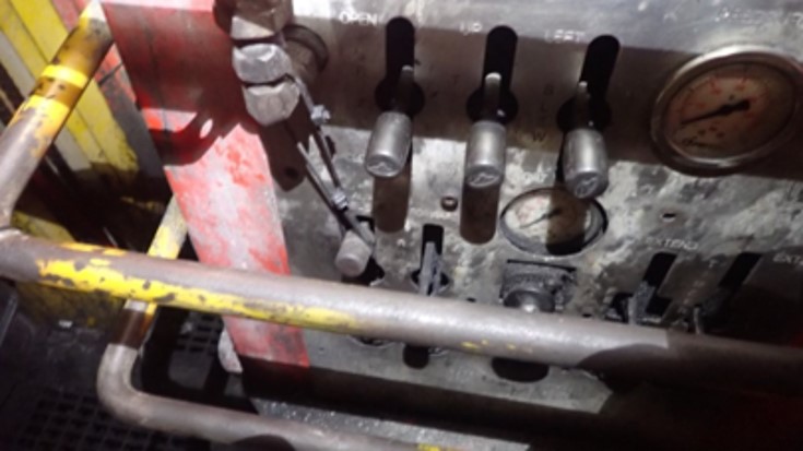 QDS bolter control station showing the zip-tie restraining the dead-man lever