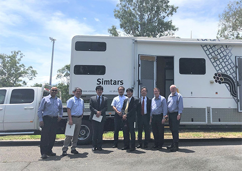 Japanese delegation to SIMTARS in front of SIMTARS truck