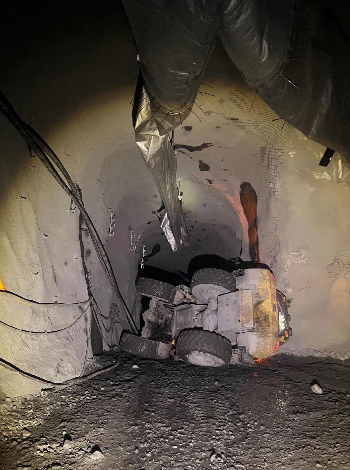 Tool carrier lying on its side inside a mine