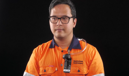 A man in high vis clothing wearing a sampling device correctly