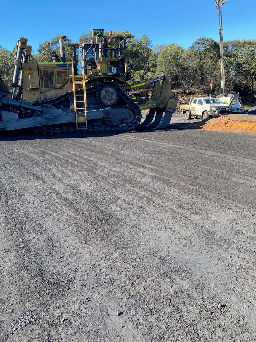 View of the incident scene showing the bulldozer and ute
